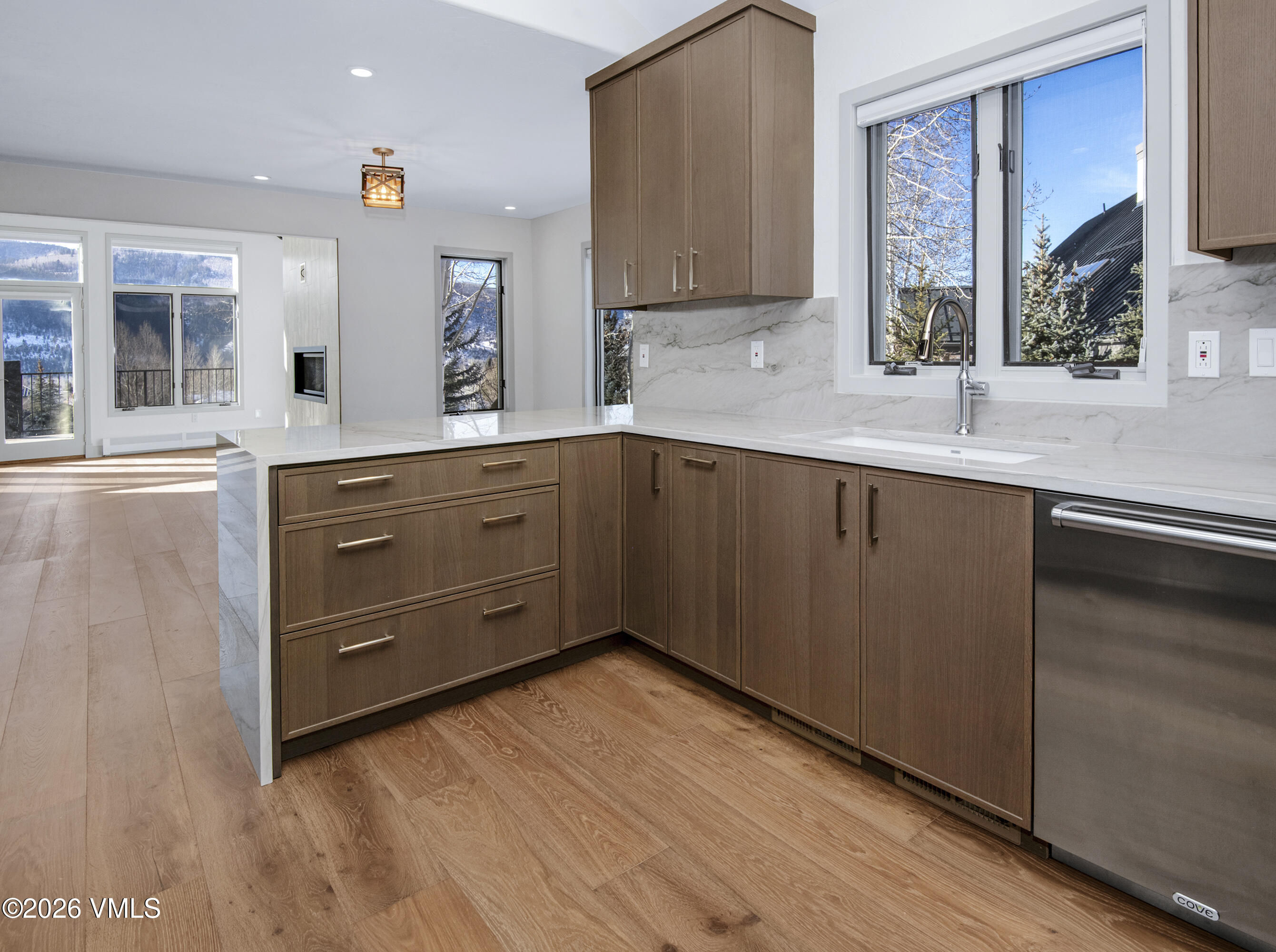 567 Singletree Road Edwards, CO 81632 - Photo 13 of 38 a kitchen with granite countertop wooden cabinets and white appliances
