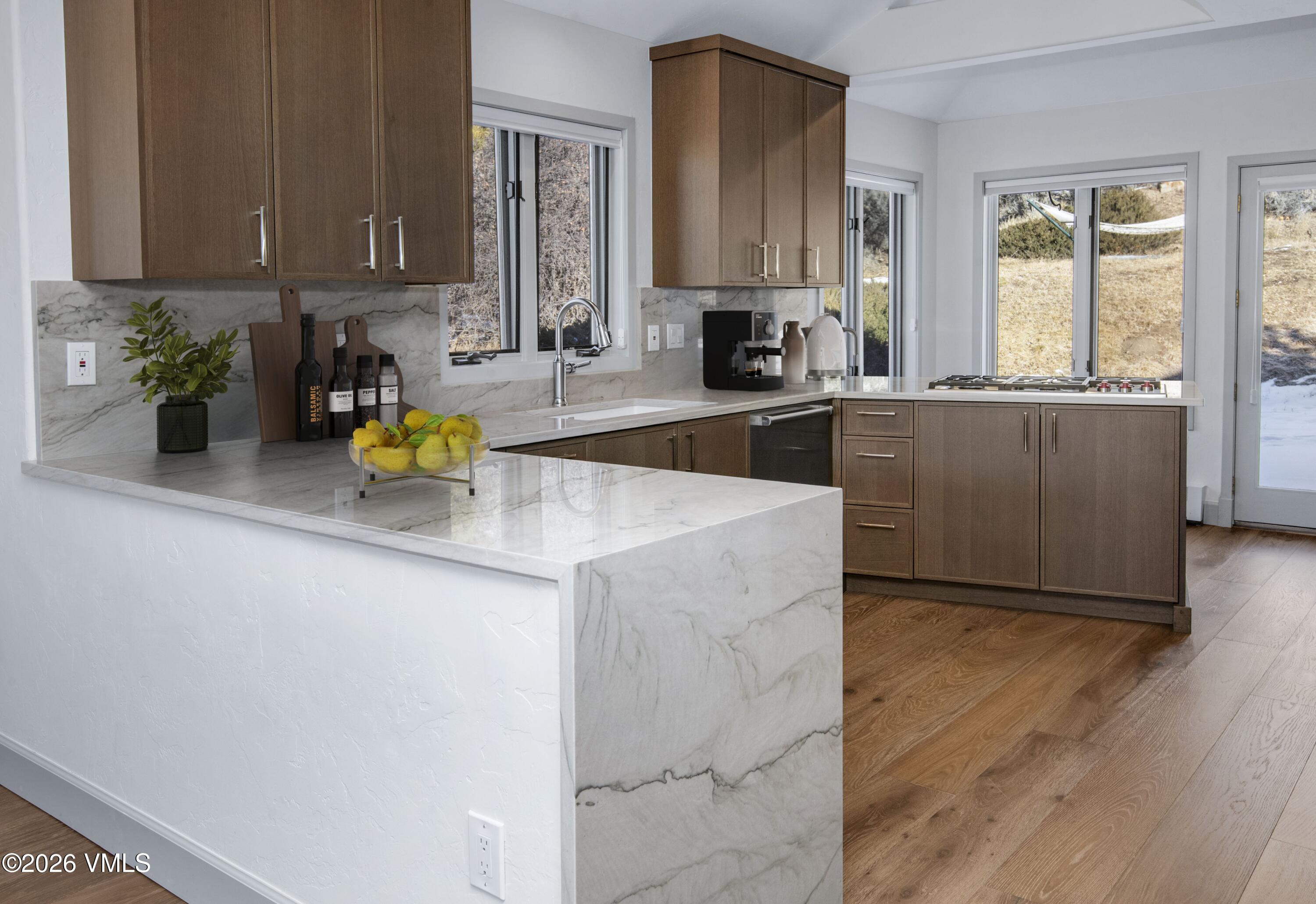 567 Singletree Road Edwards, CO 81632 - Photo 16 of 38 a kitchen with a sink a counter cabinets and appliances