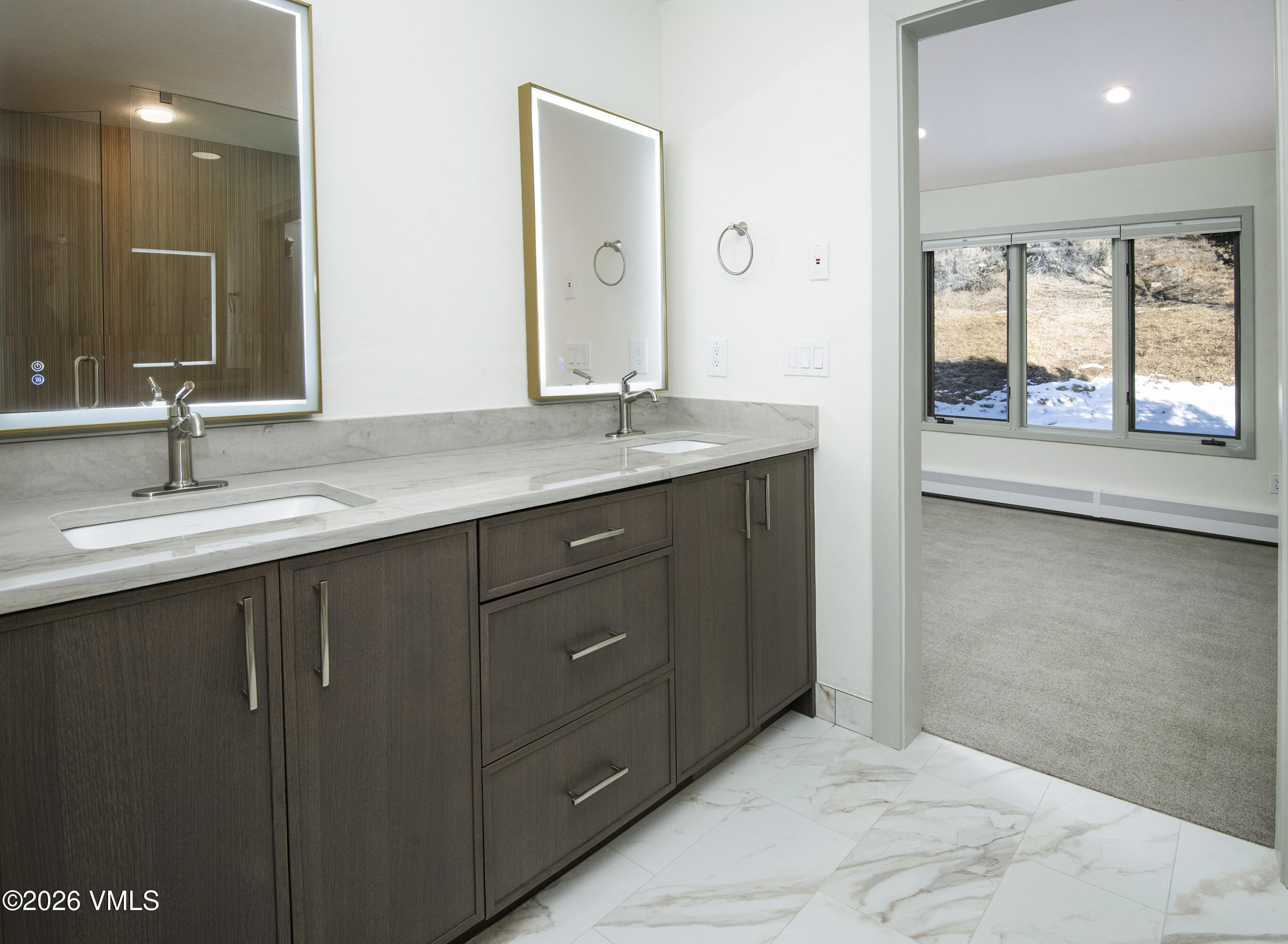 567 Singletree Road Edwards, CO 81632 - Photo 24 of 38 a bathroom with a double vanity sink and a large mirror