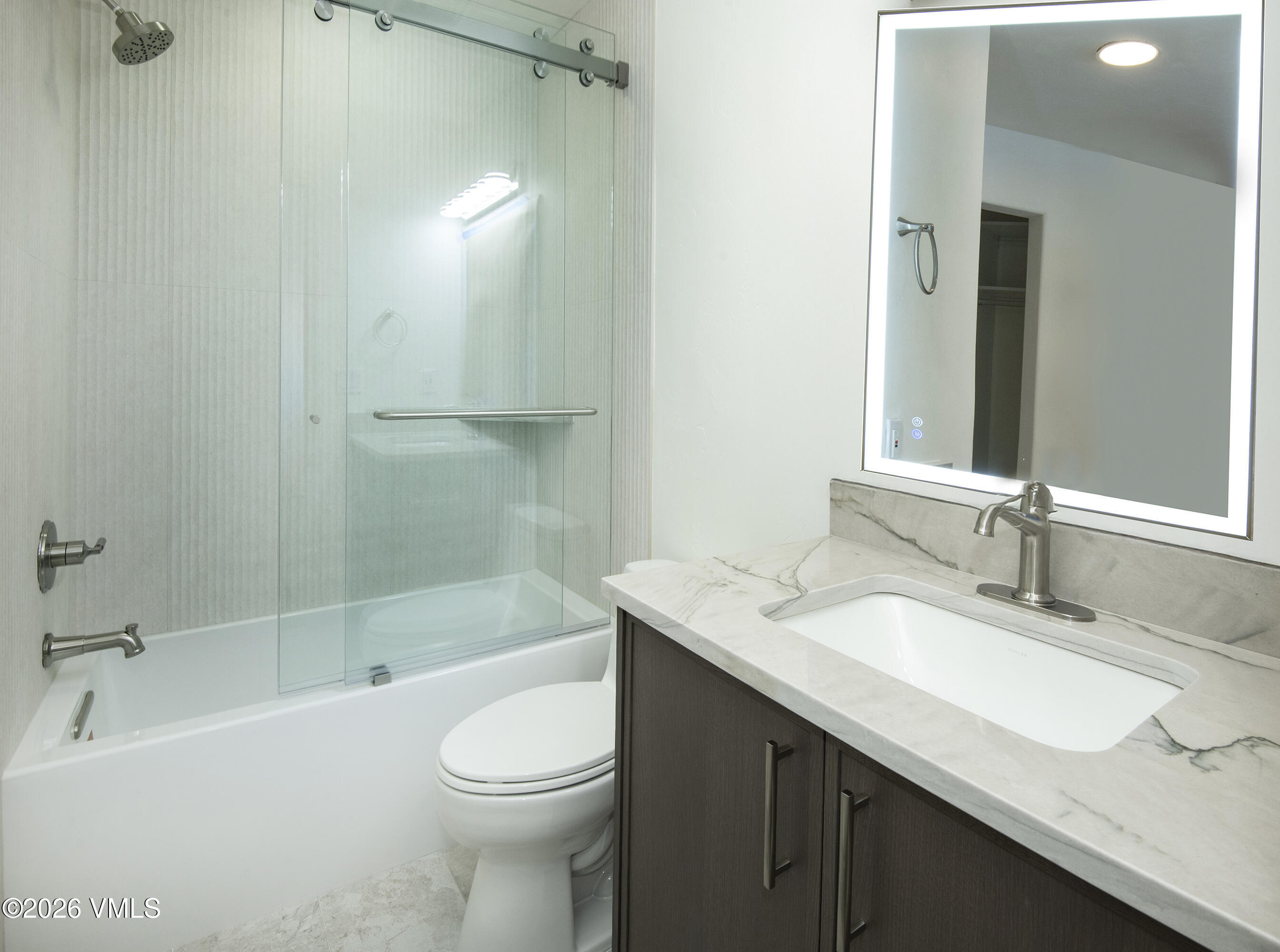 567 Singletree Road Edwards, CO 81632 - Photo 29 of 38 a bathroom with a granite countertop sink toilet and shower