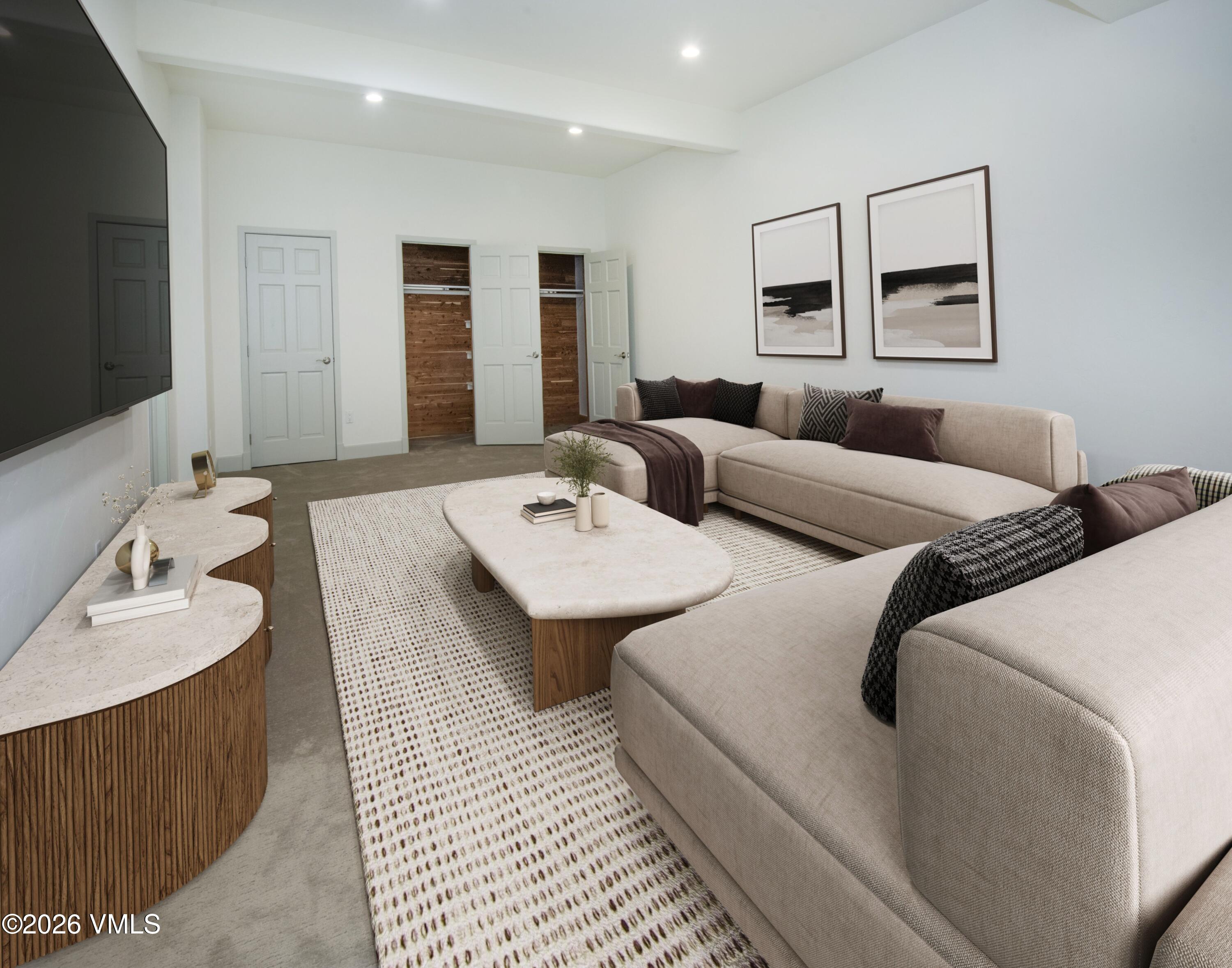 567 Singletree Road Edwards, CO 81632 - Photo 32 of 38 a living room with a couch and a flat screen tv