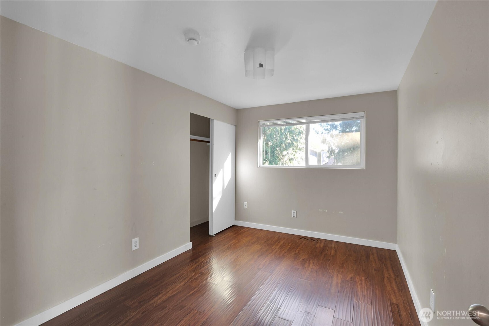 18518 131st Avenue Southeast Renton, WA 98058 - Photo 13 of 34 an empty room with wooden floor and windows
