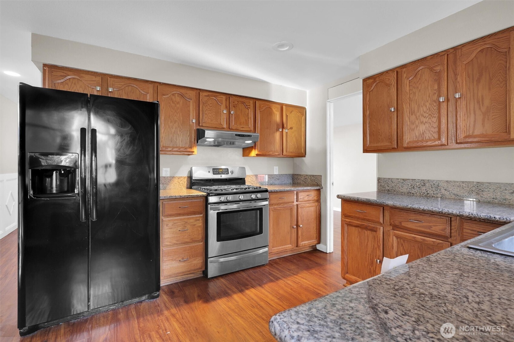 18518 131st Avenue Southeast Renton, WA 98058 - Photo 7 of 34 a kitchen with a refrigerator stove and sink