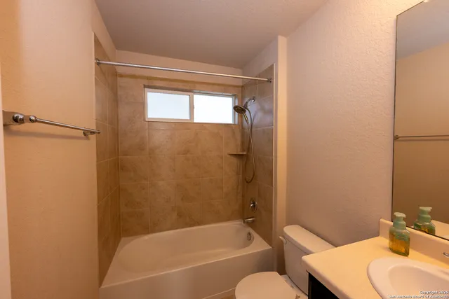 a bathroom with a tub and a sink