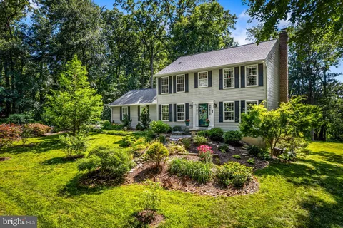 a front view of a house with a yard and fountain