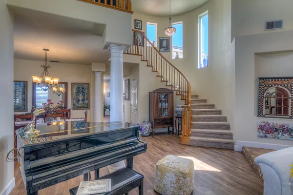 a living room with furniture and wooden floor