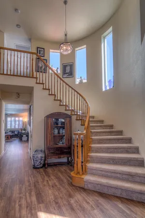 a bedroom with two beds and painting on the wall