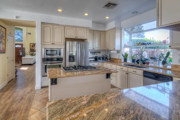 a living room with furniture a large window and a fireplace