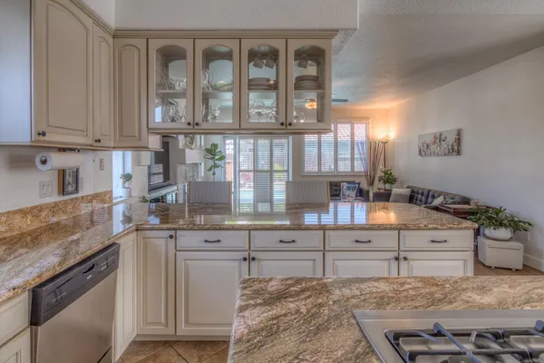 a kitchen with a table chairs cabinets and wooden floor