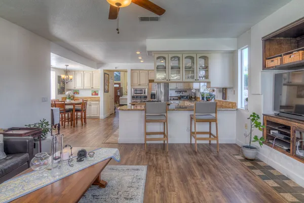 a living room with furniture and wooden floor