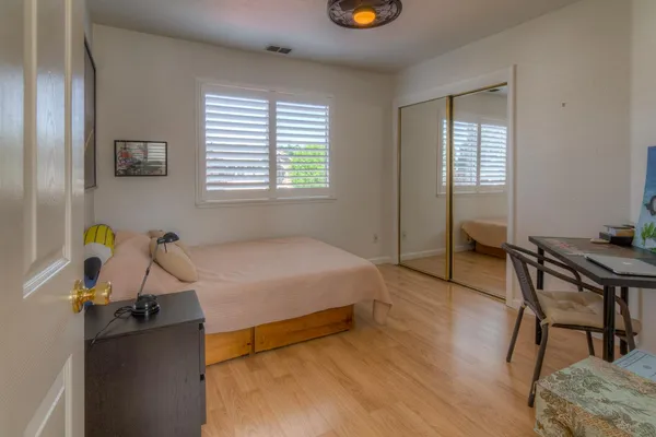 a large bathroom with a sink a toilet a mirror and bathtub