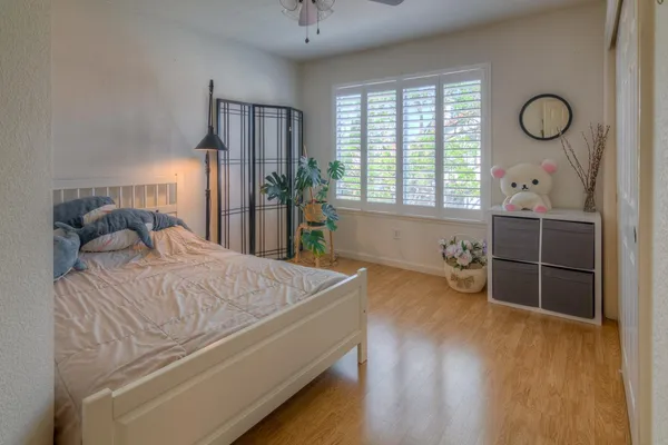 a spacious bathroom with a double vanity sink a mirror a bathtub and next to a window