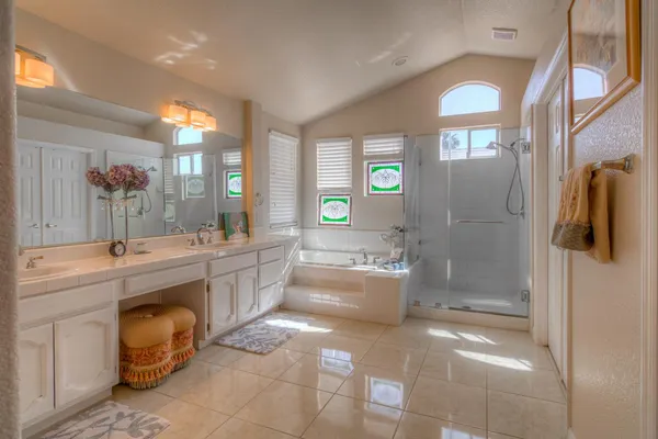 a view of a chair and tables in the patio area of the house