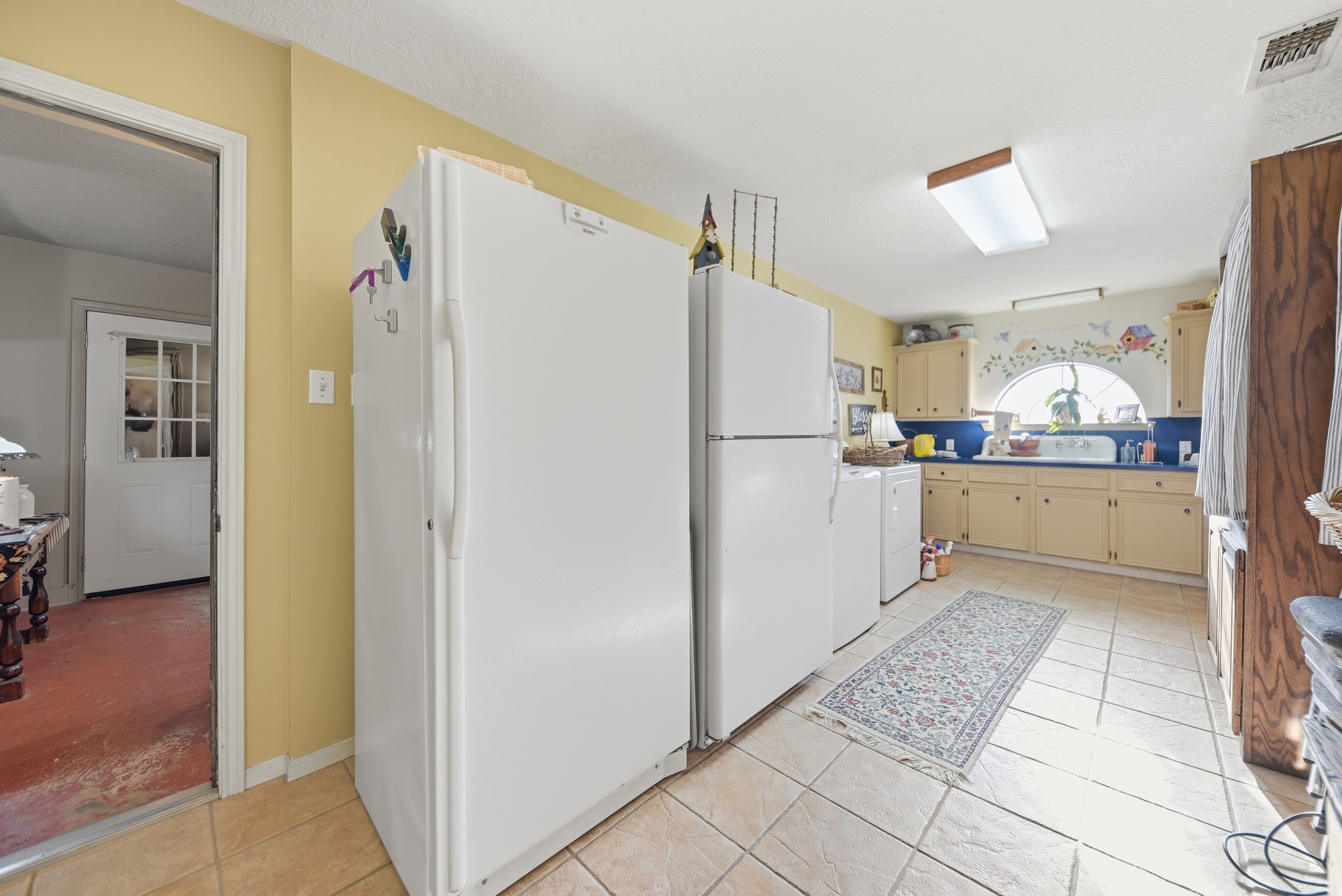 6950 Old Mill Creek Road Brenham, TX 77833 - Photo 22 of 40 a kitchen with a refrigerator a stove and a sink