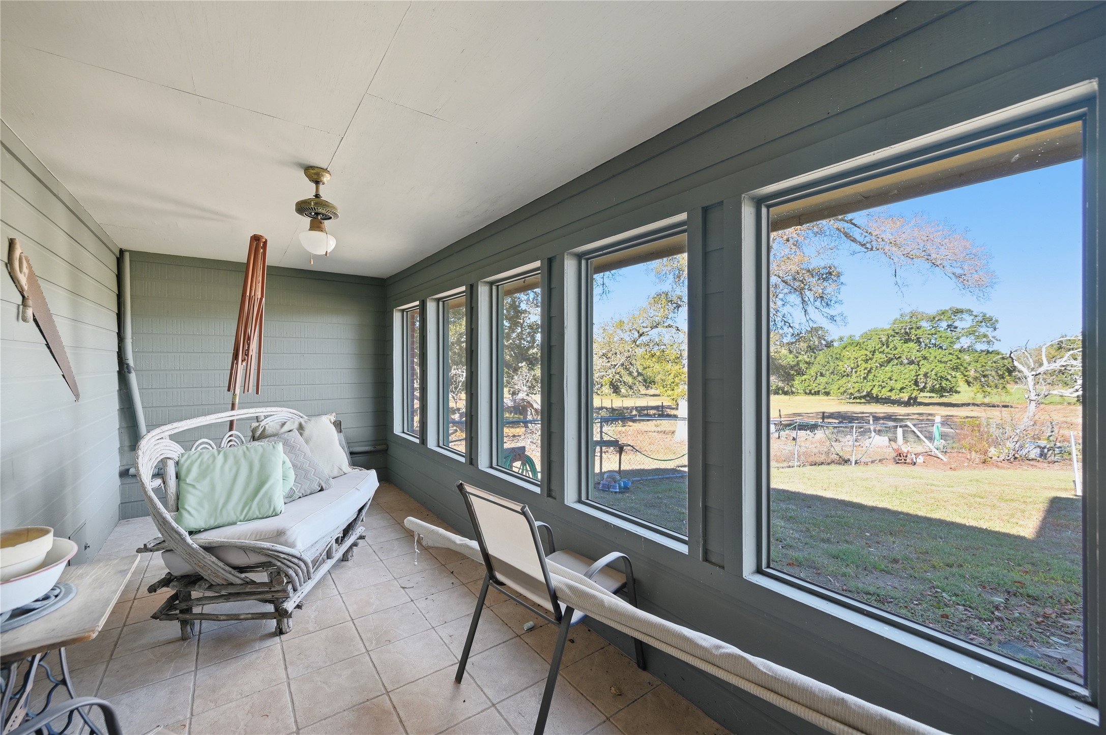 6950 Old Mill Creek Road Brenham, TX 77833 - Photo 4 of 40 a living room with furniture and a floor to ceiling window