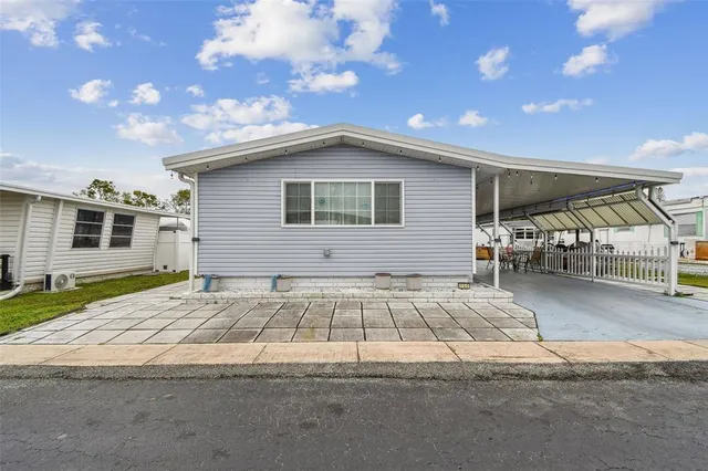 a backyard of a house with table and chairs