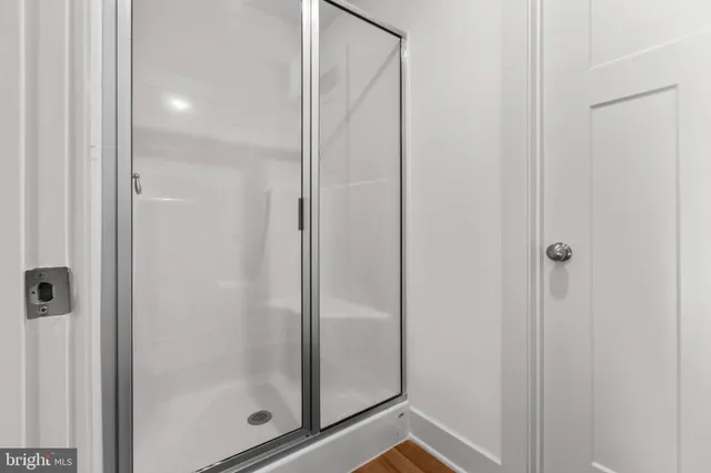 a bathroom with a glass shower door