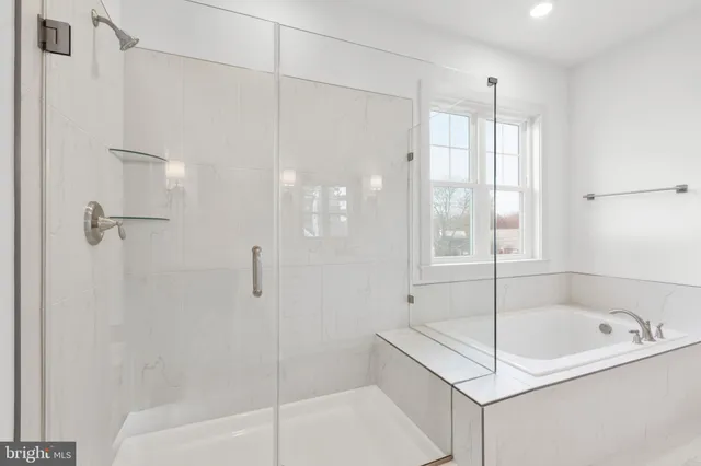 a bathroom with a bathtub and shower