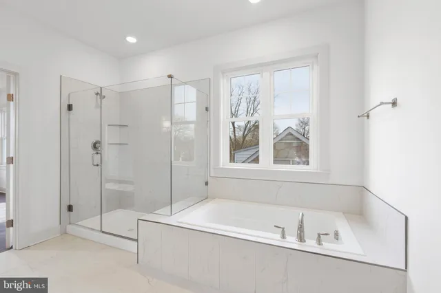 a white bath tub sitting next to a shower