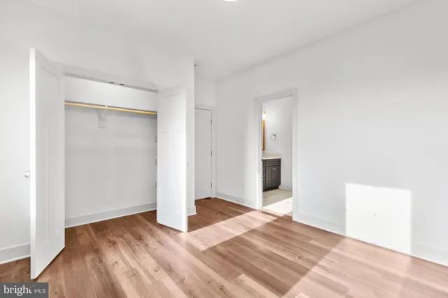 a view of a room with wooden floor and a bathroom