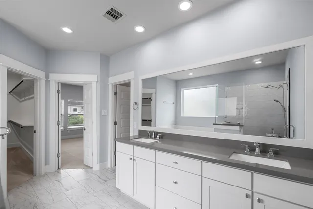 a kitchen with refrigerator a microwave a stove and white cabinets with wooden floor