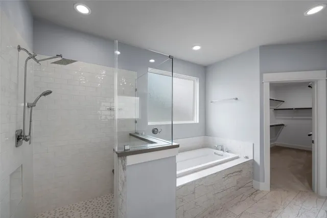 a view of an empty room with wooden floor stairs and a way to kitchen