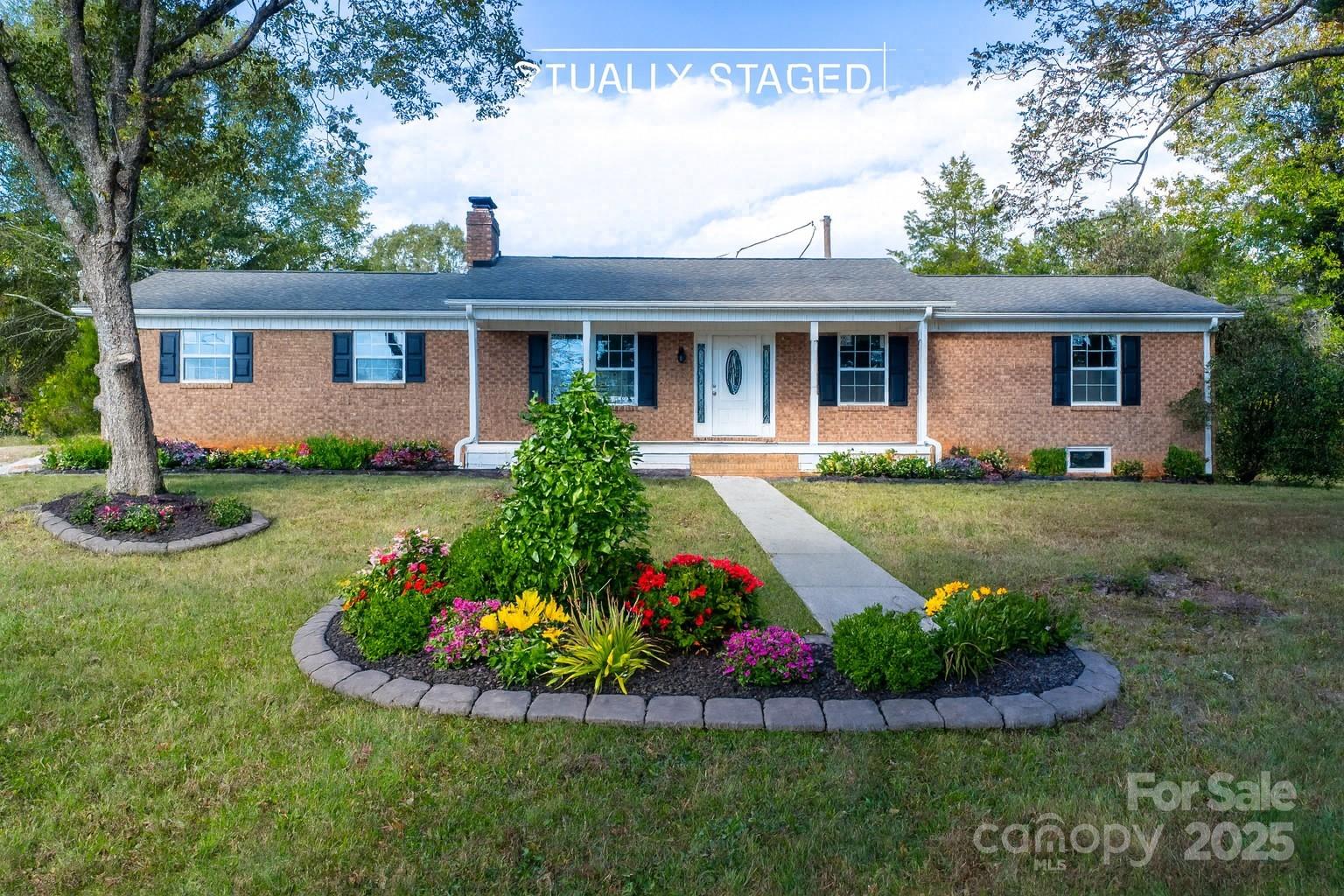 a front view of a house with a garden