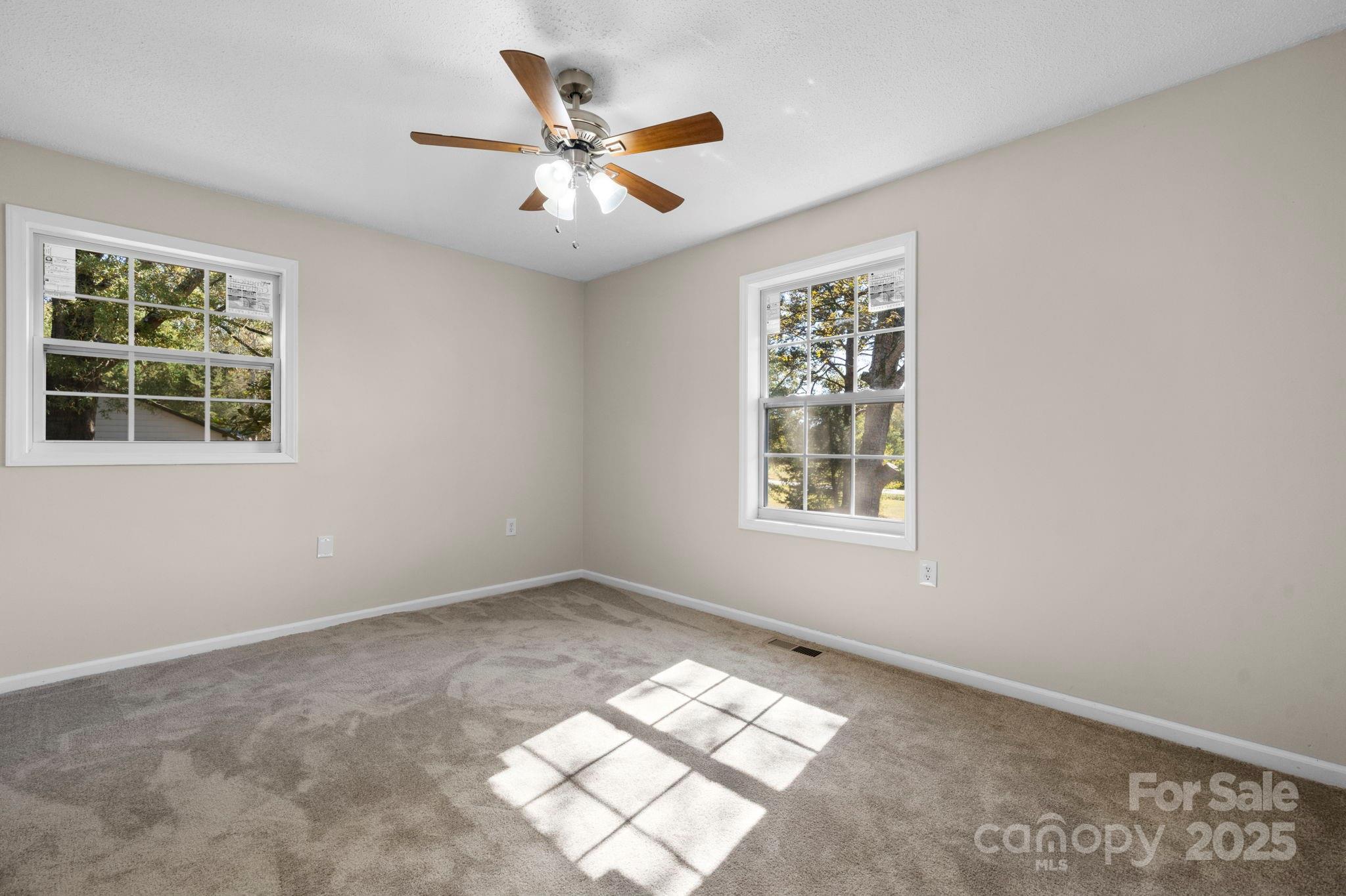 5613 Springs Road Conover, NC 28613 - Photo 12 of 23 an empty room with windows and fan