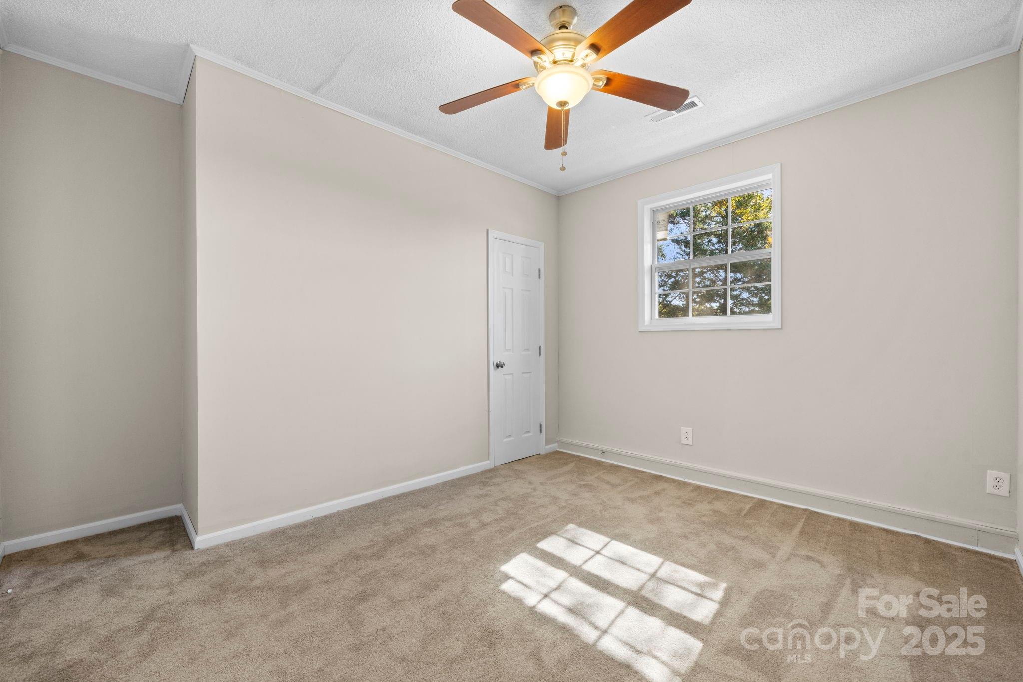 5613 Springs Road Conover, NC 28613 - Photo 14 of 23 an empty room with windows and fan