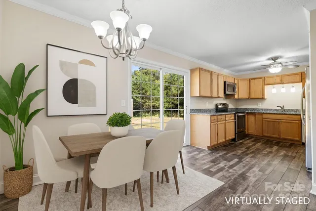 a kitchen with a table chairs a sink and appliances