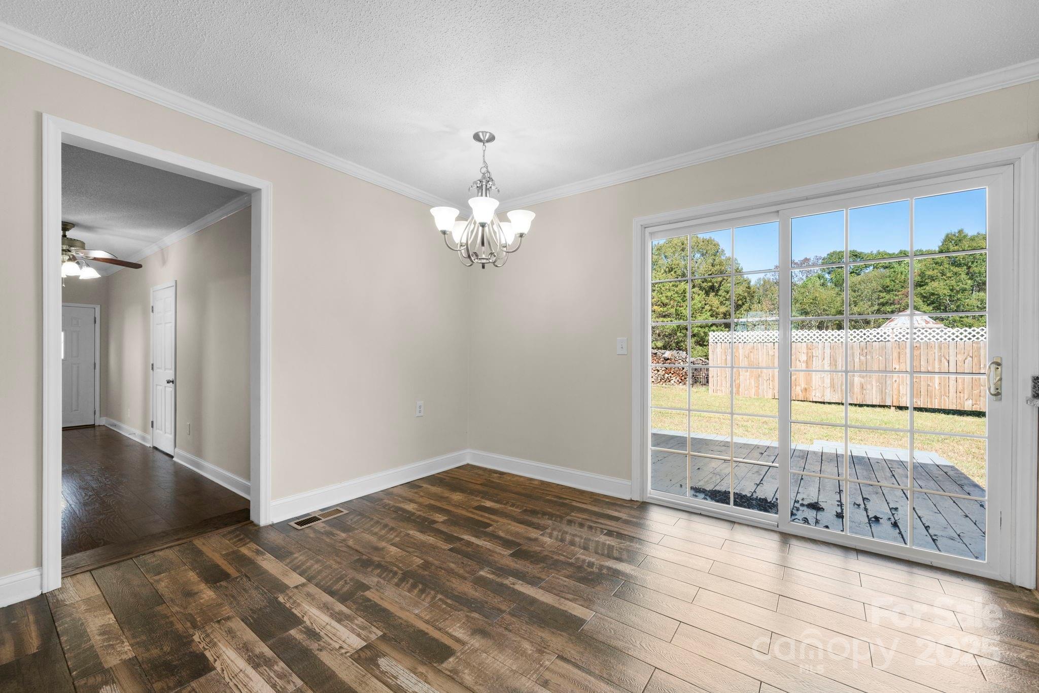 5613 Springs Road Conover, NC 28613 - Photo 4 of 23 wooden floor in an empty room with a window