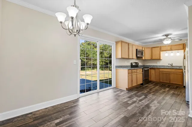 a kitchen with a stove a sink and cabinets