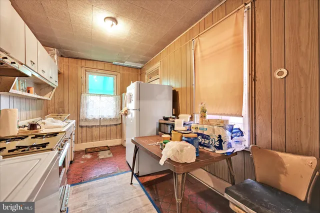 a kitchen with a stove a sink and a refrigerator