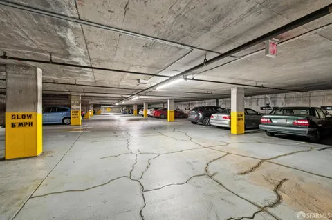 a view of parking garage with cars
