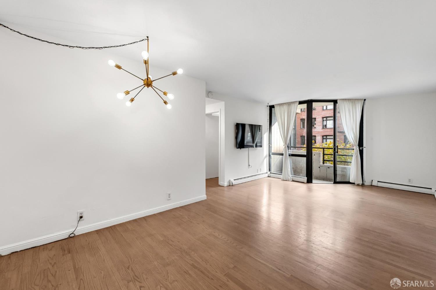 900 Bush Street, Unit 309 San Francisco, CA 94109 - Photo 4 of 25 a view of a kitchen with a sink refrigerator and wooden floor