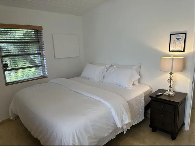 a bathroom with a sink a toilet a mirror and shower