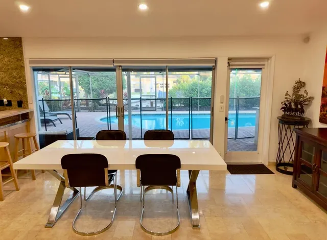 a view of a dining room with furniture a chandelier and wooden floor