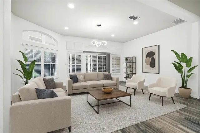 a living room with furniture potted plant and a window