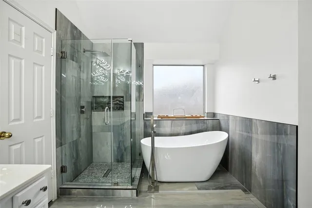 a bathroom with a bathtub and shower