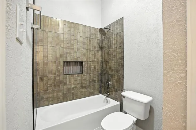 a bathroom with a toilet and a bathtub