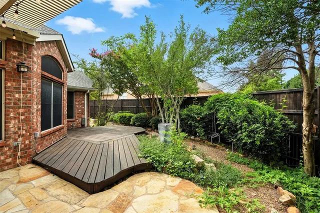 a view of backyard with a patio and plants