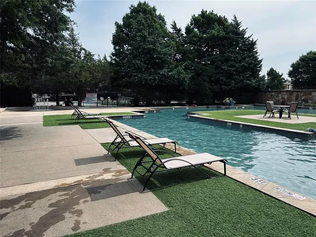 a view of swimming pool with a yard
