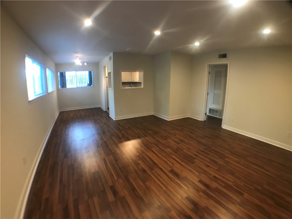 706 West 34th Street, Unit 101 Austin, TX 78705 - Photo 2 of 2 an empty room with wooden floor and windows