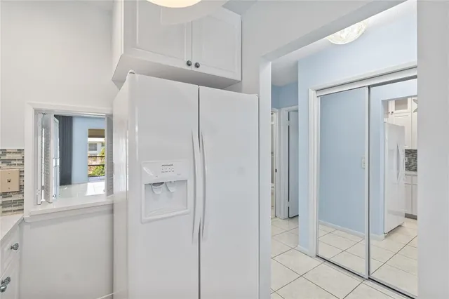 an empty room with windows and mirror