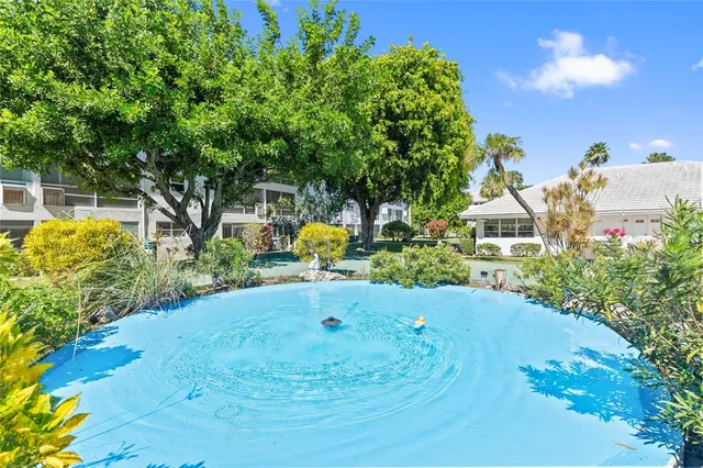 a view of a patio with couches chairs and a fire pit and a yard