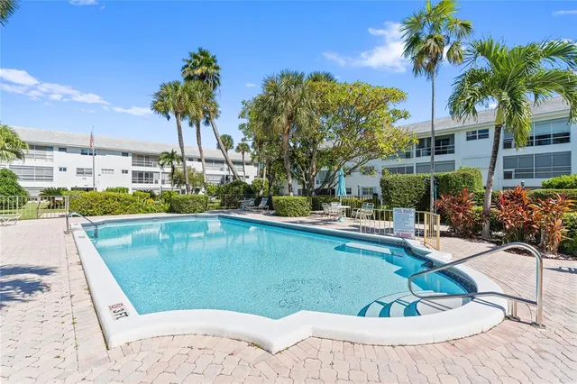 a view of a white house with a big yard