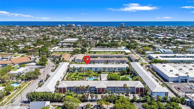 a view of a livingroom with wooden floor and furniture