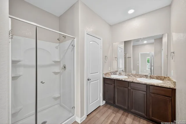 a white bath tub sitting next to a shower