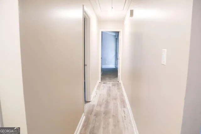 a view of a room with wooden floor