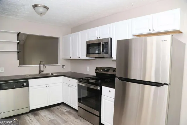 a kitchen with a sink a stove and refrigerator